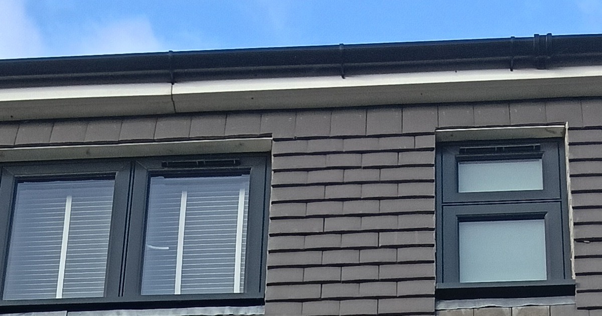 Anthracite grey uPVC flush casement windows installed in a dormer roof, East London